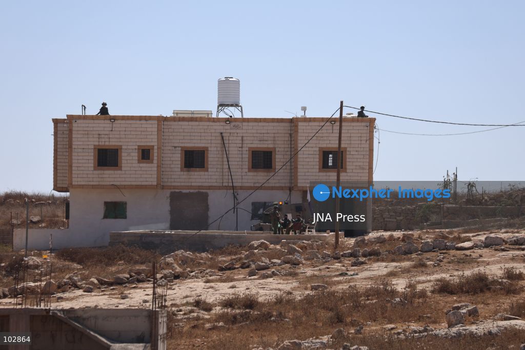 WADI AL-RAKHIM, YATTA, HEBRON, PALESTINE – OCTOBER 7, 2026: Israeli settlers continued to surround the home of Palestinian Yusuf Shnaran’s family in Wadi al-Rakhim, east of Yatta, south of Hebron, amid the presence of Israeli forces in the area since the previous night. According to the provided information, settlers had attacked the house and assaulted family members, injuring two of them. The situation continued on October 7 as settlers remained around the family home while Israeli forces were present in the area. Photo by Mosab Shawar / JNA Press. (Photo by Mosab shawer/JNA Press via Nexpher Images)