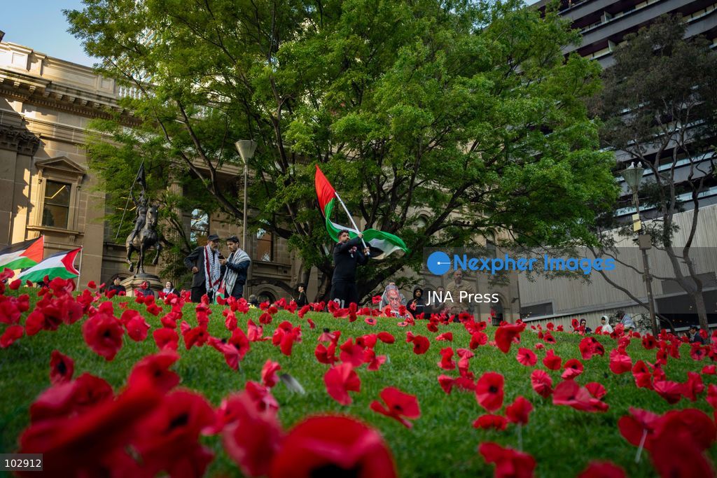MELBOURNE, AUSTRALIA – OCTOBER 7, 2026: A day-long vigil in solidarity with the people of Gaza was held at the State Library of Victoria, with attendees taking part in a sit-in from 10:00 AM to 5:00 PM, followed by a commemoration from 5:00 PM to 6:00 PM to honour and remember people killed in Gaza. During the vigil, attendees made paper poppies and placed them throughout the garden in front of the library. A car marked with numerous bullet holes, presented as a representation of the vehicle in which Hind Rajab was trapped and killed in Gaza, was displayed at the site. A recording of Rajab's final call for help was also played over a speaker. The names and ages of people who had died were read aloud during the commemoration. Photo by Huda Shehzad / JNA Press. (Photo by Huda Shehzad/JNA Press via Nexpher Images)