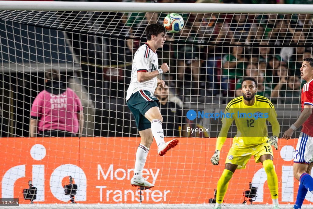 Armando González #14 of Mexico national team heads the ball against goalkeeper Lawrence Vigouroux #12 of Chile during the International Friendly football match between Mexico and Chile at Los Angeles Memorial Coliseum on October 6, 2026 in Pasadena, California. (Photo by Arturo Cordero / Eyepix Group) (Photo by Arturo Cordero / Eyepix Group/Eyepix via Nexpher Images)