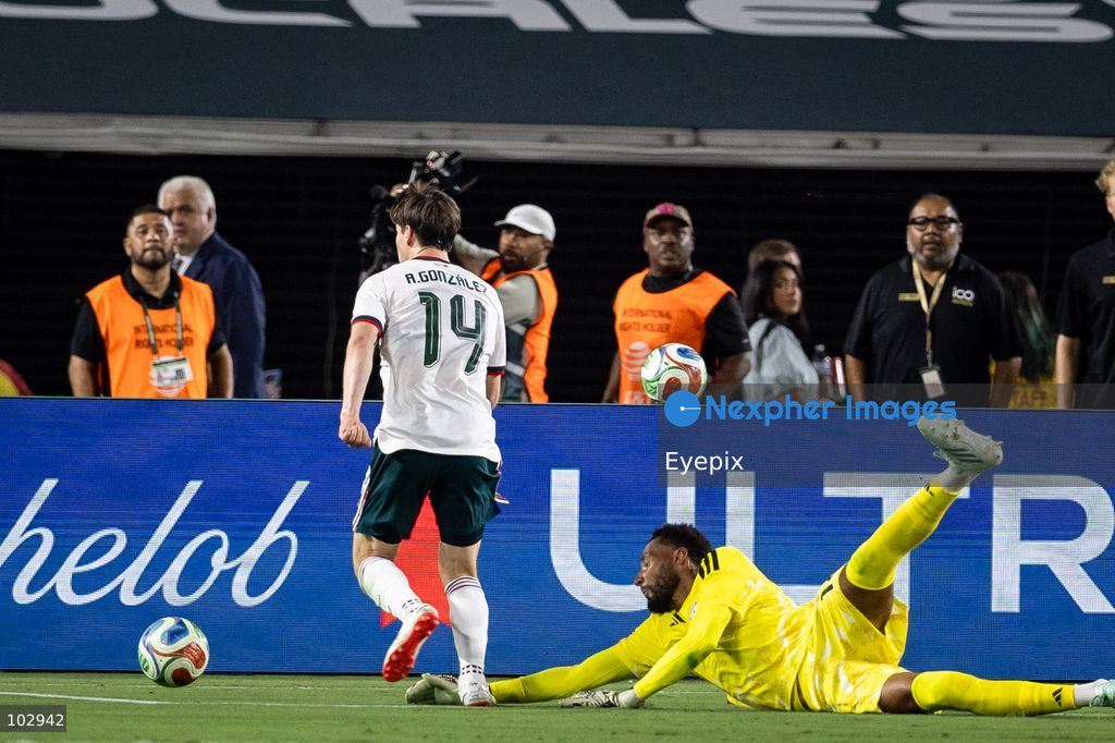 Goalkeeper Lawrence Vigouroux #12 of Chile dives for the ball against Armando González #14 of Mexico national team during the International Friendly football match between Mexico and Chile at Los Angeles Memorial Coliseum on October 6, 2026 in Pasadena, California. (Photo by Arturo Cordero / Eyepix Group) (Photo by Arturo Cordero / Eyepix Group/Eyepix via Nexpher Images)