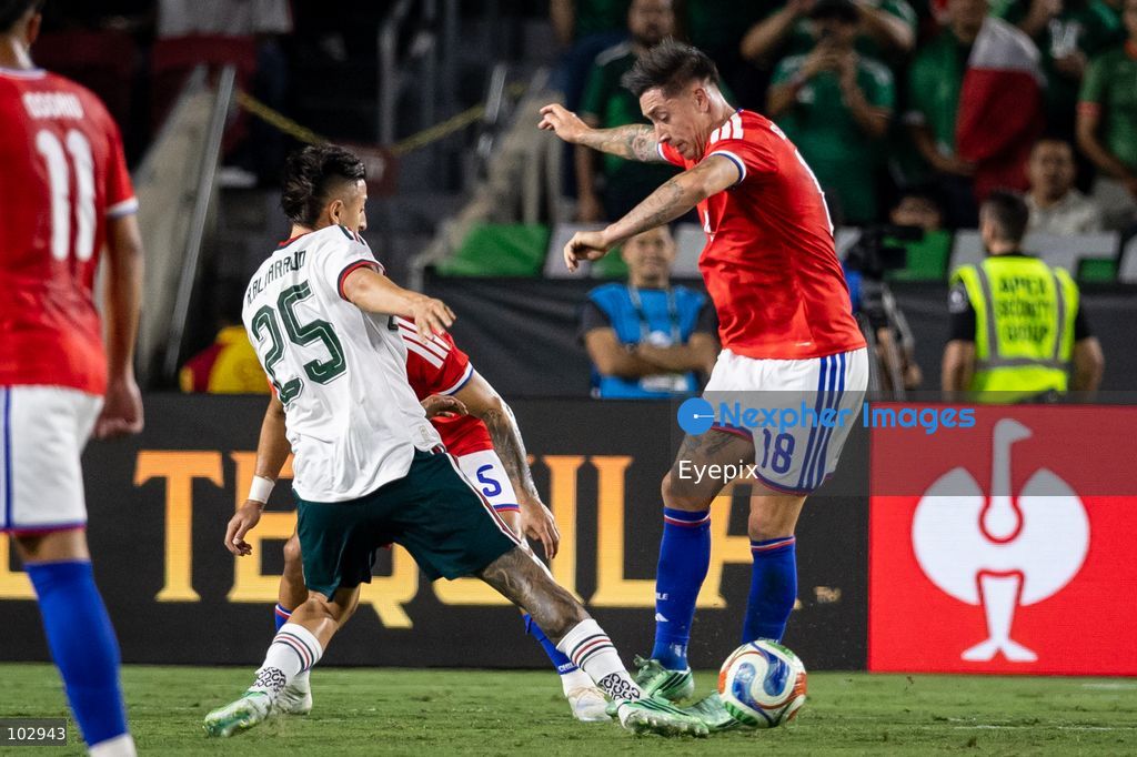 Roberto Alvarado #25 of Mexico national team and Rodrigo Echeverría #18 of Chile national team battle for the ball during the International Friendly football match between Mexico and Chile at Los Angeles Memorial Coliseum on October 6, 2026 in Pasadena, California. (Photo by Arturo Cordero / Eyepix Group) (Photo by Arturo Cordero / Eyepix Group/Eyepix via Nexpher Images)