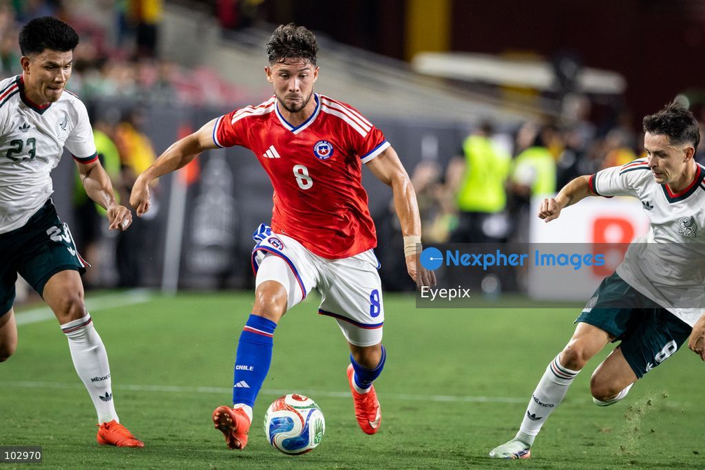 Felipe Loyola #8 of Chile national team is pressured by Jesus Gallardo #23 and Álvaro Fidalgo #8 of Mexico national team during the International Friendly football match between Mexico and Chile at Los Angeles Memorial Coliseum on October 6, 2026 in Pasadena, California. (Photo by Arturo Cordero / Eyepix Group) (Photo by Arturo Cordero / Eyepix Group/Eyepix via Nexpher Images)