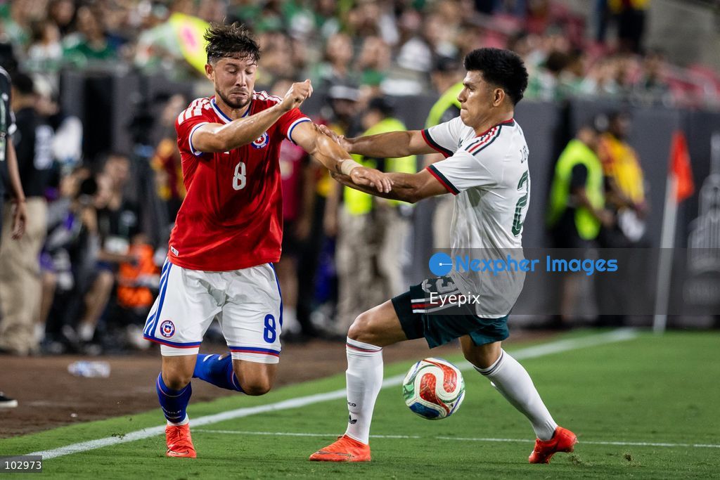 Jesus Gallardo #23 of Mexico national team and Felipe Loyola #8 of Chile national team battle for the ball during the International Friendly football match between Mexico and Chile at Los Angeles Memorial Coliseum on October 6, 2026 in Pasadena, California. (Photo by Arturo Cordero / Eyepix Group) (Photo by Arturo Cordero / Eyepix Group/Eyepix via Nexpher Images)