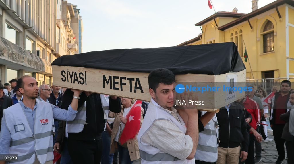 IZMIR, TURKEY, OCTOBER 7, 2026: Supporters of the opposition YENI Parti protest after Izmir Metropolitan Mayor Cemil Tugay joined President Recep Tayyip Erdogan's ruling AKP. Tugay was elected mayor as a CHP candidate in the 2024 local elections before leaving the party earlier this year. Protesters attempted to march toward Izmir City Hall carrying a black wreath, black carnations and a symbolic coffin while chanting for Tugay to resign. Police blocked parts of the march with barricades, riot police and water cannon vehicles, with protesters leaving flowers and the wreath near police barriers. Photo by Turgay Kilic / JNA PRESS (Photo by Turgay Kilic/JNA Press via Nexpher Images)