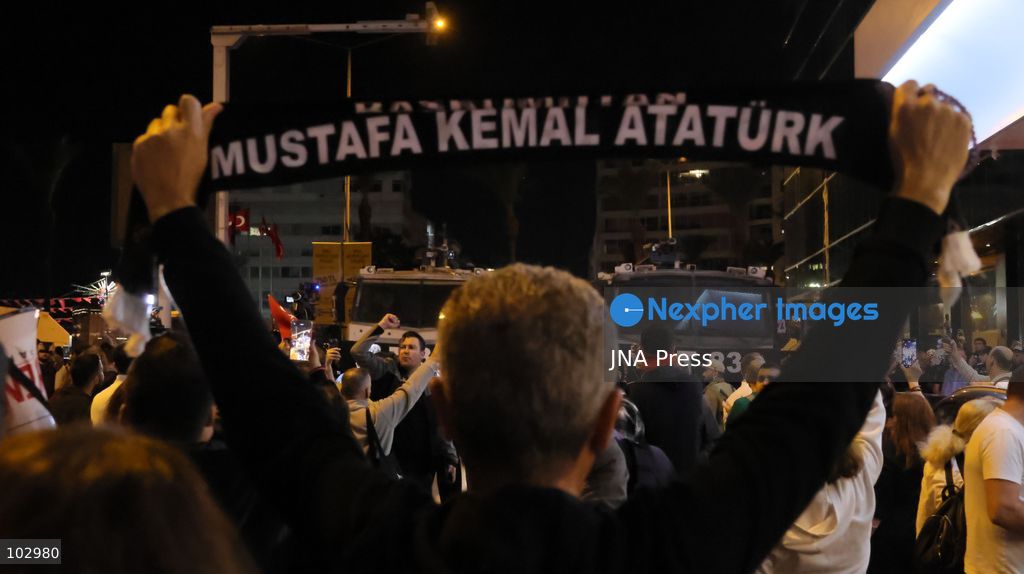 IZMIR, TURKEY, OCTOBER 7, 2026: Supporters of the opposition YENI Parti protest after Izmir Metropolitan Mayor Cemil Tugay joined President Recep Tayyip Erdogan's ruling AKP. Tugay was elected mayor as a CHP candidate in the 2024 local elections before leaving the party earlier this year. Protesters attempted to march toward Izmir City Hall carrying a black wreath, black carnations and a symbolic coffin while chanting for Tugay to resign. Police blocked parts of the march with barricades, riot police and water cannon vehicles, with protesters leaving flowers and the wreath near police barriers. Photo by Turgay Kilic / JNA PRESS (Photo by Turgay Kilic/JNA Press via Nexpher Images)