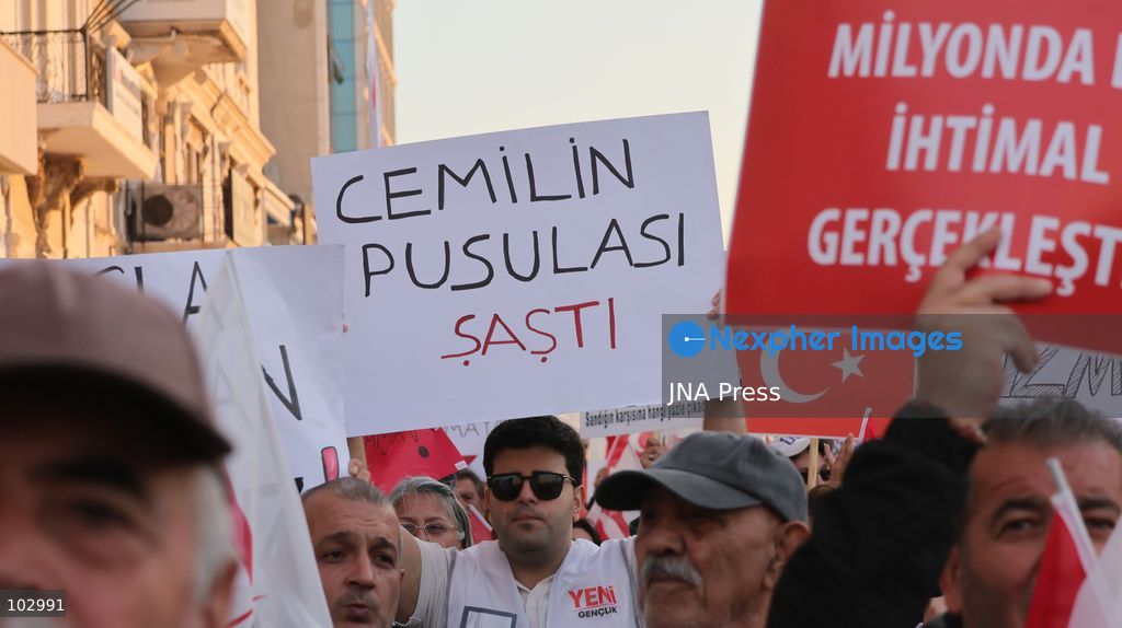 IZMIR, TURKEY, OCTOBER 7, 2026: Supporters of the opposition YENI Parti protest after Izmir Metropolitan Mayor Cemil Tugay joined President Recep Tayyip Erdogan's ruling AKP. Tugay was elected mayor as a CHP candidate in the 2024 local elections before leaving the party earlier this year. Protesters attempted to march toward Izmir City Hall carrying a black wreath, black carnations and a symbolic coffin while chanting for Tugay to resign. Police blocked parts of the march with barricades, riot police and water cannon vehicles, with protesters leaving flowers and the wreath near police barriers. Photo by Turgay Kilic / JNA PRESS (Photo by Turgay Kilic/JNA Press via Nexpher Images)