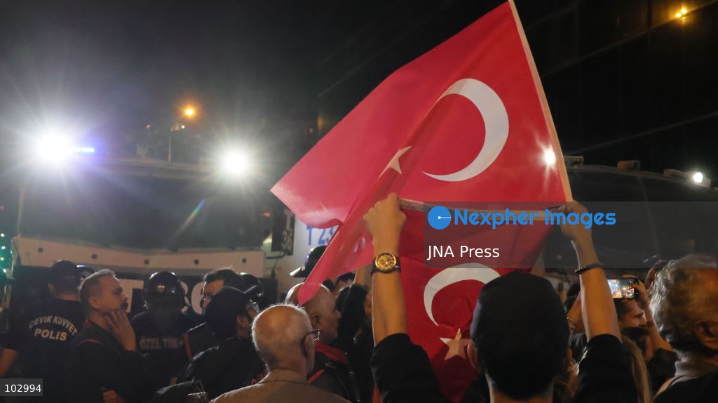 IZMIR, TURKEY, OCTOBER 7, 2026: Supporters of the opposition YENI Parti protest after Izmir Metropolitan Mayor Cemil Tugay joined President Recep Tayyip Erdogan's ruling AKP. Tugay was elected mayor as a CHP candidate in the 2024 local elections before leaving the party earlier this year. Protesters attempted to march toward Izmir City Hall carrying a black wreath, black carnations and a symbolic coffin while chanting for Tugay to resign. Police blocked parts of the march with barricades, riot police and water cannon vehicles, with protesters leaving flowers and the wreath near police barriers. Photo by Turgay Kilic / JNA PRESS (Photo by Turgay Kilic/JNA Press via Nexpher Images)