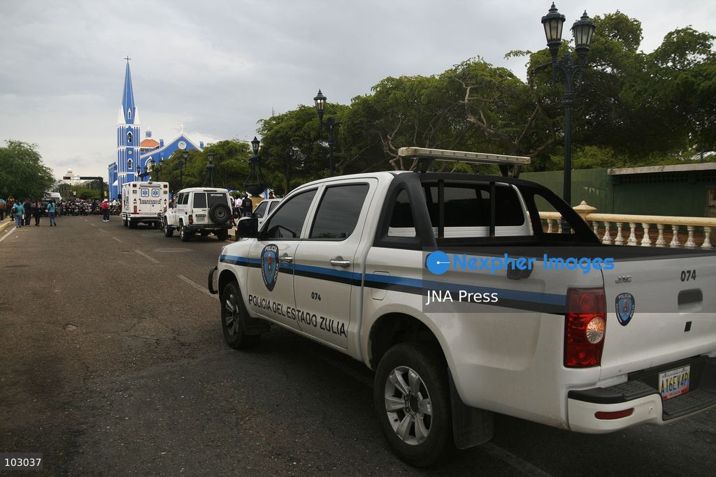 MARACAIBO, VENEZUELA, OCTOBER 7, 2026: Government supporters and state security personnel gather in central Maracaibo during an event marking the 14th anniversary of Hugo Chavez's 2012 presidential election victory. Zulia Governor Luis Caldera attended the commemoration as government supporters marched through the city. The event took place amid heightened political tensions and continuing public complaints over prolonged electricity outages in Zulia. Opposition activists from Vente Venezuela alleged that government resources and security deployments were used to obstruct a separate protest over electricity rationing, a claim that could not be independently verified. Photo by Humberto Matheus / JNA PRESS (Photo by Humberto Matheus/JNA Press via Nexpher Images)