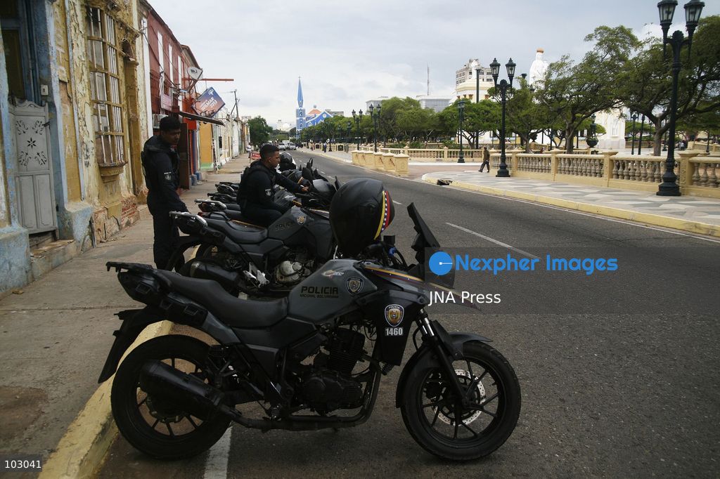 MARACAIBO, VENEZUELA, OCTOBER 7, 2026: Government supporters and state security personnel gather in central Maracaibo during an event marking the 14th anniversary of Hugo Chavez's 2012 presidential election victory. Zulia Governor Luis Caldera attended the commemoration as government supporters marched through the city. The event took place amid heightened political tensions and continuing public complaints over prolonged electricity outages in Zulia. Opposition activists from Vente Venezuela alleged that government resources and security deployments were used to obstruct a separate protest over electricity rationing, a claim that could not be independently verified. Photo by Humberto Matheus / JNA PRESS (Photo by Humberto Matheus/JNA Press via Nexpher Images)