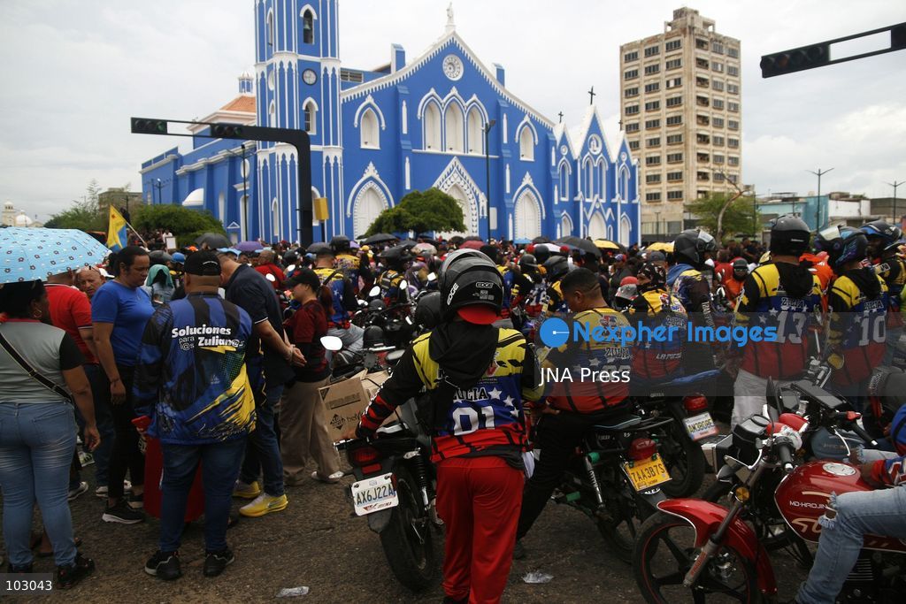 MARACAIBO, VENEZUELA, OCTOBER 7, 2026: Government supporters and state security personnel gather in central Maracaibo during an event marking the 14th anniversary of Hugo Chavez's 2012 presidential election victory. Zulia Governor Luis Caldera attended the commemoration as government supporters marched through the city. The event took place amid heightened political tensions and continuing public complaints over prolonged electricity outages in Zulia. Opposition activists from Vente Venezuela alleged that government resources and security deployments were used to obstruct a separate protest over electricity rationing, a claim that could not be independently verified. Photo by Humberto Matheus / JNA PRESS (Photo by Humberto Matheus/JNA Press via Nexpher Images)