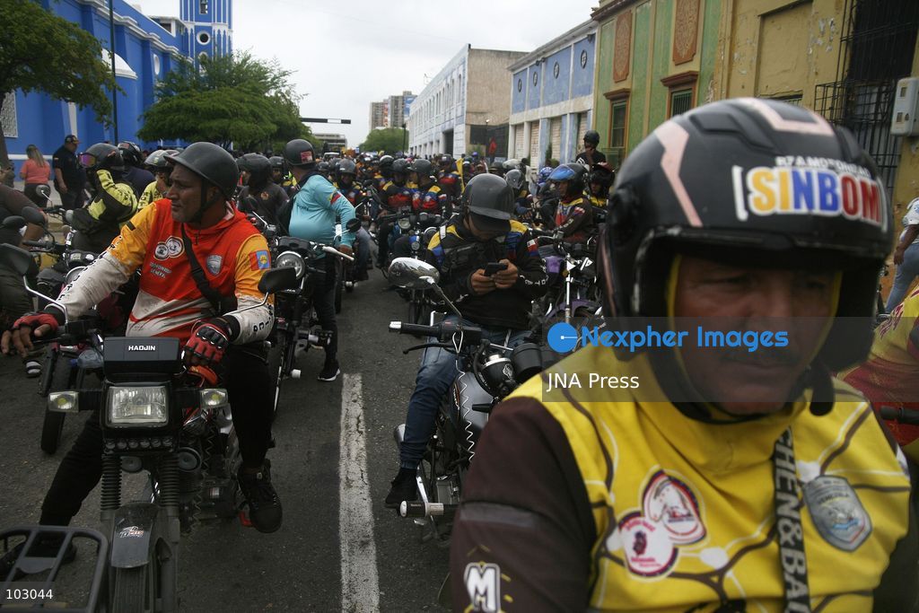 MARACAIBO, VENEZUELA, OCTOBER 7, 2026: Government supporters and state security personnel gather in central Maracaibo during an event marking the 14th anniversary of Hugo Chavez's 2012 presidential election victory. Zulia Governor Luis Caldera attended the commemoration as government supporters marched through the city. The event took place amid heightened political tensions and continuing public complaints over prolonged electricity outages in Zulia. Opposition activists from Vente Venezuela alleged that government resources and security deployments were used to obstruct a separate protest over electricity rationing, a claim that could not be independently verified. Photo by Humberto Matheus / JNA PRESS (Photo by Humberto Matheus/JNA Press via Nexpher Images)
