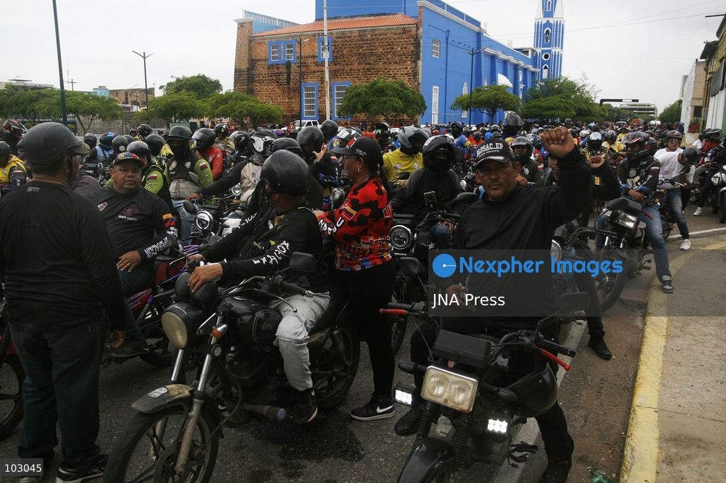 MARACAIBO, VENEZUELA, OCTOBER 7, 2026: Government supporters and state security personnel gather in central Maracaibo during an event marking the 14th anniversary of Hugo Chavez's 2012 presidential election victory. Zulia Governor Luis Caldera attended the commemoration as government supporters marched through the city. The event took place amid heightened political tensions and continuing public complaints over prolonged electricity outages in Zulia. Opposition activists from Vente Venezuela alleged that government resources and security deployments were used to obstruct a separate protest over electricity rationing, a claim that could not be independently verified. Photo by Humberto Matheus / JNA PRESS (Photo by Humberto Matheus/JNA Press via Nexpher Images)