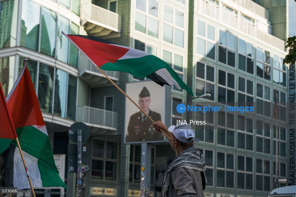 BERLIN, GERMANY, OCTOBER 7, 2026: Demonstrators gather at Checkpoint Charlie in central Berlin to mark three years since the start of the Gaza war. Participants protest against Israel’s military actions in Gaza, which they describe as genocide, and express solidarity with Palestinians. Photo by Nikos Kanistras / JNA Press. (Photo by Nikos Kanistras/JNA Press via Nexpher Images)