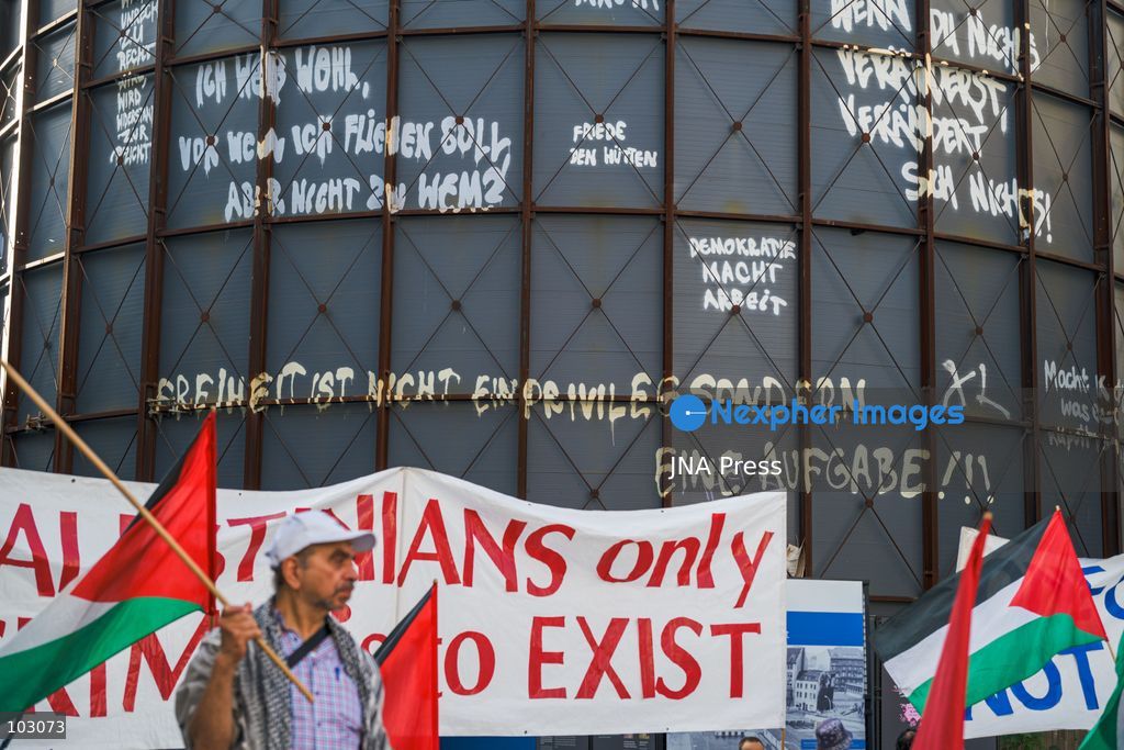 BERLIN, GERMANY, OCTOBER 7, 2026: Demonstrators gather at Checkpoint Charlie in central Berlin to mark three years since the start of the Gaza war. Participants protest against Israel’s military actions in Gaza, which they describe as genocide, and express solidarity with Palestinians. Photo by Nikos Kanistras / JNA Press. (Photo by Nikos Kanistras/JNA Press via Nexpher Images)