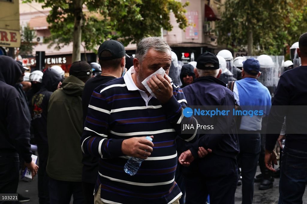 TIRANA, ALBANIA – OCTOBER 8, 2026: Citizens, local activists and supporters of the opposition gather outside the Albanian Parliament as lawmakers debate and vote on proposed changes to the country’s administrative-territorial division. The reform proposes reducing the number of municipalities from 61 to 46 through the merger of 15 existing municipalities, including Divjakë, Poliçan and Memaliaj. Residents and representatives of municipalities affected by the proposed changes joined the protest, calling for their municipalities to be preserved. Protesters displayed banners and slogans opposing the proposed mergers. Tensions escalated between protesters and police, with reports of eggs and smoke-producing devices being thrown and police using tear gas and pepper spray. Several people received first aid after being affected by the spray. Protesters also set fire to garbage bins during the confrontation. The demonstration took place as Parliament considered the proposed territorial reform. Photo by Vlasov Sulaj / JNA Press. (Photo by Vlasov Sulaj/JNA Press via Nexpher Images)