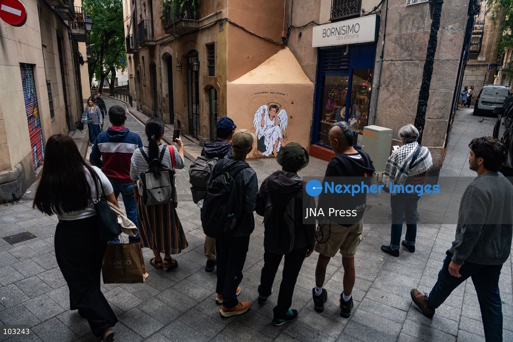 BARCELONA, SPAIN, OCTOBER 8, 2026: Tourists and local residents photograph a mural by urban artist TVBoy depicting Maricarmen Abascal as an angel holding a key in Barcelona. Titled "Maricarmen Para Siempre," the artwork pays tribute to the elderly woman whose eviction and subsequent death sparked widespread housing protests across Spain. Abascal became a symbol of the movement demanding stronger tenant protections and measures against evictions. Photo by Marc Asensio Clupes / JNA Press. (Photo by Marc Asensio Clupes/JNA Press via Nexpher Images)