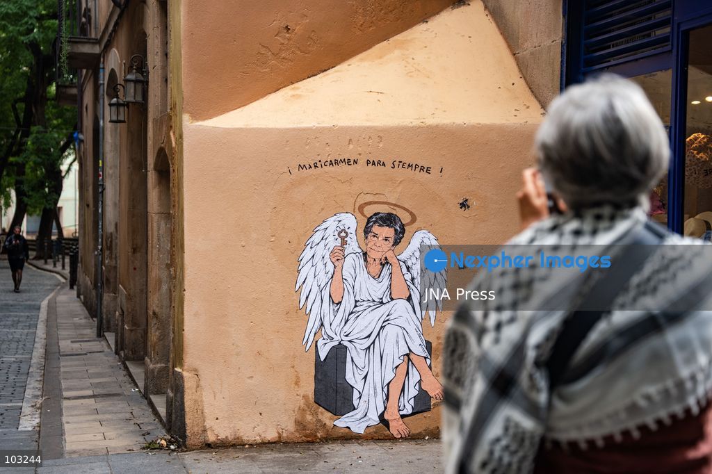 BARCELONA, SPAIN, OCTOBER 8, 2026: Tourists and local residents photograph a mural by urban artist TVBoy depicting Maricarmen Abascal as an angel holding a key in Barcelona. Titled "Maricarmen Para Siempre," the artwork pays tribute to the elderly woman whose eviction and subsequent death sparked widespread housing protests across Spain. Abascal became a symbol of the movement demanding stronger tenant protections and measures against evictions. Photo by Marc Asensio Clupes / JNA Press. (Photo by Marc Asensio Clupes/JNA Press via Nexpher Images)