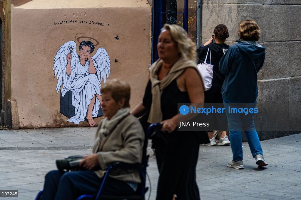 BARCELONA, SPAIN, OCTOBER 8, 2026: Tourists and local residents photograph a mural by urban artist TVBoy depicting Maricarmen Abascal as an angel holding a key in Barcelona. Titled "Maricarmen Para Siempre," the artwork pays tribute to the elderly woman whose eviction and subsequent death sparked widespread housing protests across Spain. Abascal became a symbol of the movement demanding stronger tenant protections and measures against evictions. Photo by Marc Asensio Clupes / JNA Press. (Photo by Marc Asensio Clupes/JNA Press via Nexpher Images)