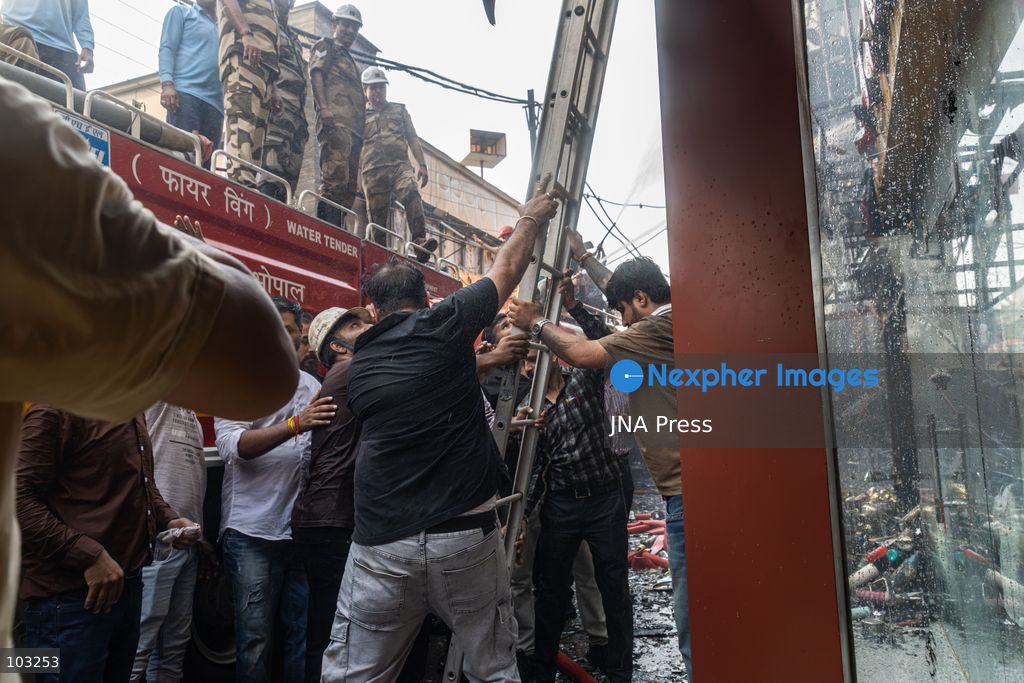 BHOPAL, MADHYA PRADESH, INDIA, OCTOBER 8, 2026: Firefighters battle a major fire at the New Market commercial area in Bhopal on Thursday afternoon. The blaze reportedly started at a fast-food outlet before spreading to several nearby shops, including clothing, kitchenware and mobile phone stores. More than 15 fire engines were deployed to contain the flames as thick smoke rose above the crowded shopping district. Photo by Sauvik Acharyya / JNA Press. (Photo by Sauvik Acharyya/JNA Press via Nexpher Images)