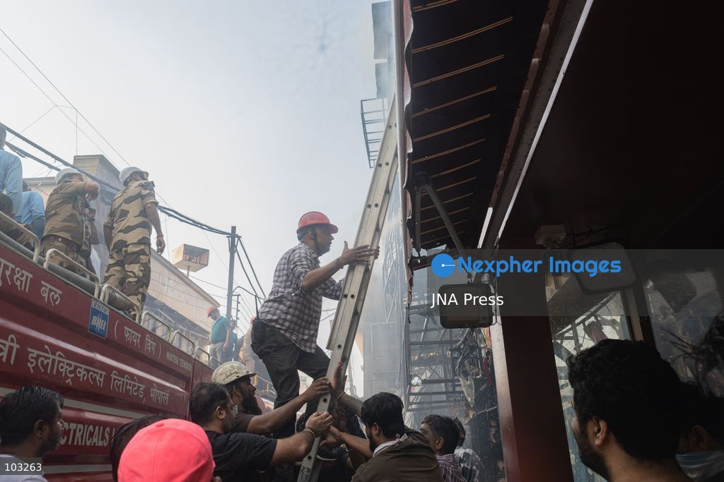 BHOPAL, MADHYA PRADESH, INDIA, OCTOBER 8, 2026: Firefighters battle a major fire at the New Market commercial area in Bhopal on Thursday afternoon. The blaze reportedly started at a fast-food outlet before spreading to several nearby shops, including clothing, kitchenware and mobile phone stores. More than 15 fire engines were deployed to contain the flames as thick smoke rose above the crowded shopping district. Photo by Sauvik Acharyya / JNA Press. (Photo by Sauvik Acharyya/JNA Press via Nexpher Images)