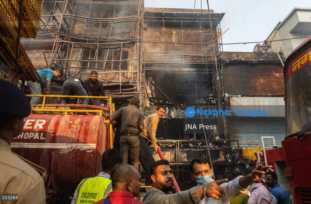 BHOPAL, MADHYA PRADESH, INDIA, OCTOBER 8, 2026: Firefighters battle a major fire at the New Market commercial area in Bhopal on Thursday afternoon. The blaze reportedly started at a fast-food outlet before spreading to several nearby shops, including clothing, kitchenware and mobile phone stores. More than 15 fire engines were deployed to contain the flames as thick smoke rose above the crowded shopping district. Photo by Sauvik Acharyya / JNA Press. (Photo by Sauvik Acharyya/JNA Press via Nexpher Images)