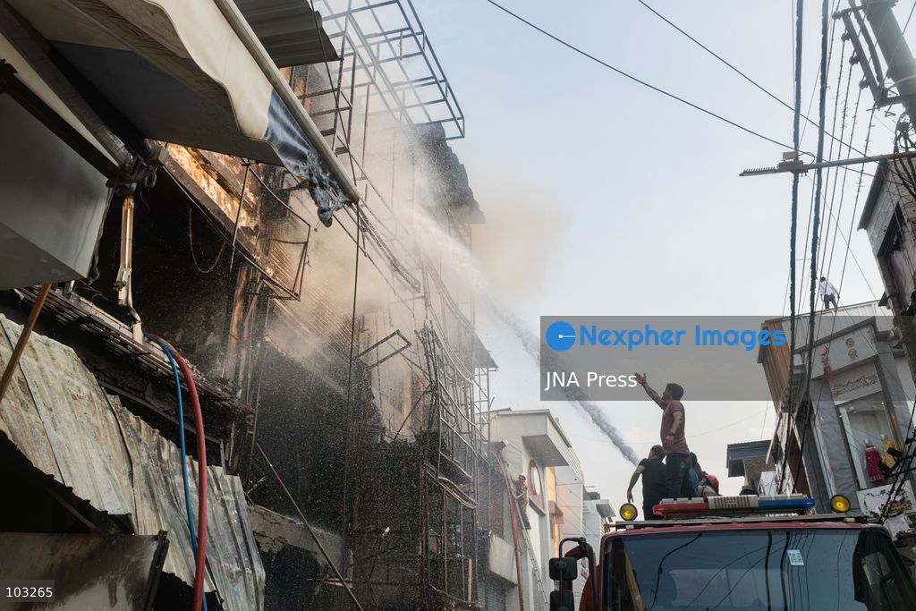 BHOPAL, MADHYA PRADESH, INDIA, OCTOBER 8, 2026: Firefighters battle a major fire at the New Market commercial area in Bhopal on Thursday afternoon. The blaze reportedly started at a fast-food outlet before spreading to several nearby shops, including clothing, kitchenware and mobile phone stores. More than 15 fire engines were deployed to contain the flames as thick smoke rose above the crowded shopping district. Photo by Sauvik Acharyya / JNA Press. (Photo by Sauvik Acharyya/JNA Press via Nexpher Images)