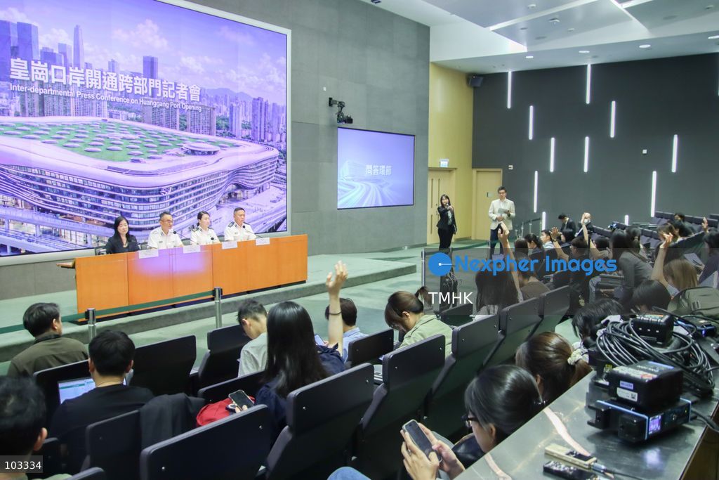 Journalists raise their hands to ask questions as representatives from the Immigration Department, Customs and Excise Department, Hong Kong Police Force and Transport Department attend a joint press conference on the opening arrangements for the new Huanggang Port at the Central Government Offices in Hong Kong on October 9, 2026. (Photo by Gordon Choi/TMHK via Nexpher Images)