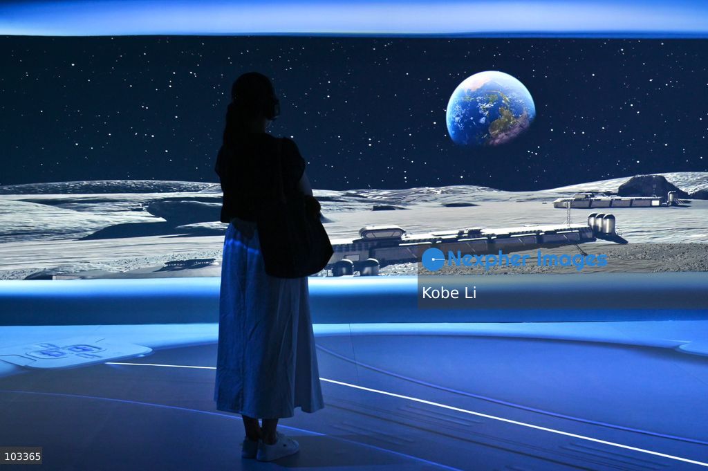 A visitor observes a large display depicting Earth and the moon at "Fly Me to the Moon – A 380,000 km Odyssey" exhibition at K11 MUSEA on October 9, 2026 in Hong Kong. (Photo by Kobe Li/Nexpher Images)