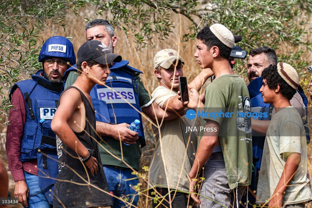 DEIR IBZI, OCCUPIED WEST BANK, OCTOBER 9, 2026: Israeli settlers confront Palestinian farmers, international activists and journalists during the annual olive harvest in the village of Deir Ibzi, west of Ramallah. According to the photographer, settlers attacked and harassed those accompanying the farmers, used pepper spray and prevented residents from completing the harvest on their agricultural land. The incident occurred during the olive harvest season, an important source of income for Palestinian farming communities in the occupied West Bank. Photo by Salman Mohsen Alkhatib / JNA Press (Photo by Salman Mohsen Alkhatib/JNA Press via Nexpher Images)