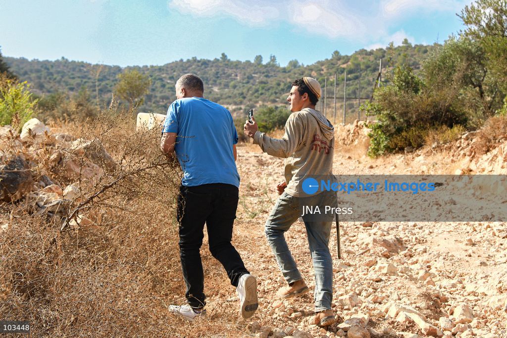 DEIR IBZI, OCCUPIED WEST BANK, OCTOBER 9, 2026: Israeli settlers confront Palestinian farmers, international activists and journalists during the annual olive harvest in the village of Deir Ibzi, west of Ramallah. According to the photographer, settlers attacked and harassed those accompanying the farmers, used pepper spray and prevented residents from completing the harvest on their agricultural land. The incident occurred during the olive harvest season, an important source of income for Palestinian farming communities in the occupied West Bank. Photo by Salman Mohsen Alkhatib / JNA Press (Photo by Salman Mohsen Alkhatib/JNA Press via Nexpher Images)