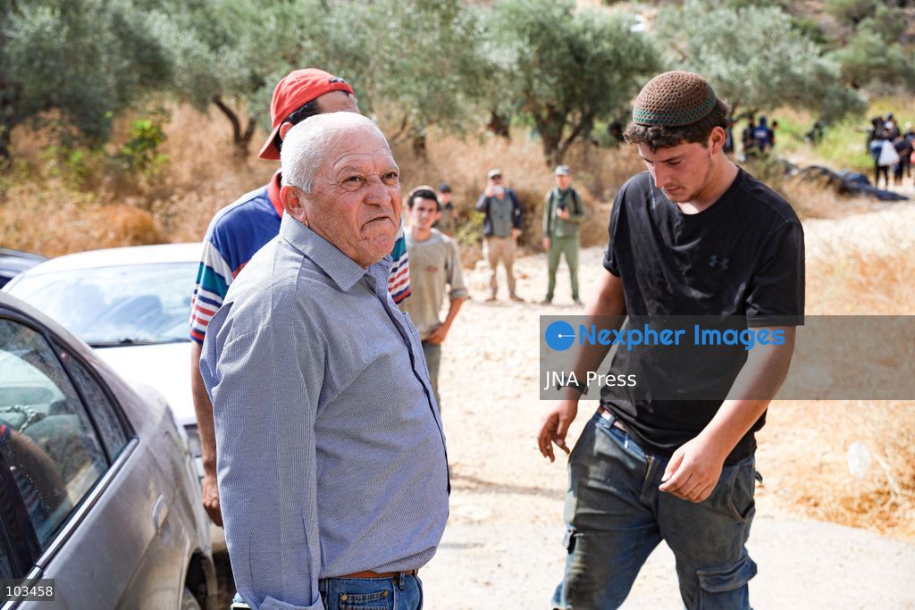 DEIR IBZI, OCCUPIED WEST BANK, OCTOBER 9, 2026: Israeli settlers confront Palestinian farmers, international activists and journalists during the annual olive harvest in the village of Deir Ibzi, west of Ramallah. According to the photographer, settlers attacked and harassed those accompanying the farmers, used pepper spray and prevented residents from completing the harvest on their agricultural land. The incident occurred during the olive harvest season, an important source of income for Palestinian farming communities in the occupied West Bank. Photo by Salman Mohsen Alkhatib / JNA Press (Photo by Salman Mohsen Alkhatib/JNA Press via Nexpher Images)