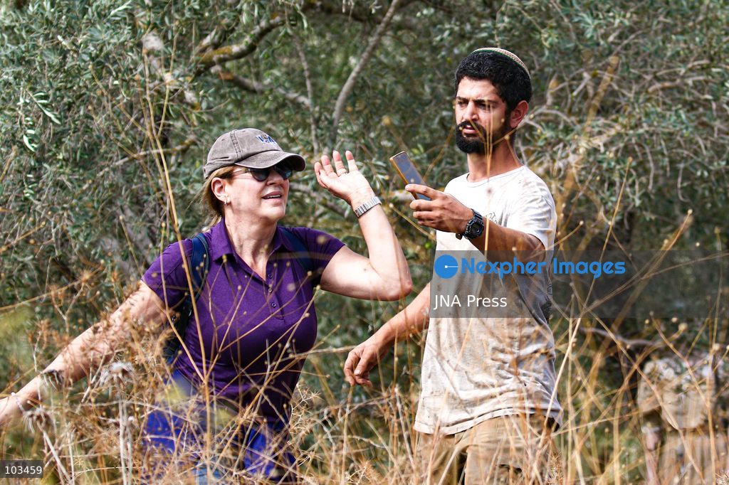 DEIR IBZI, OCCUPIED WEST BANK, OCTOBER 9, 2026: Israeli settlers confront Palestinian farmers, international activists and journalists during the annual olive harvest in the village of Deir Ibzi, west of Ramallah. According to the photographer, settlers attacked and harassed those accompanying the farmers, used pepper spray and prevented residents from completing the harvest on their agricultural land. The incident occurred during the olive harvest season, an important source of income for Palestinian farming communities in the occupied West Bank. Photo by Salman Mohsen Alkhatib / JNA Press (Photo by Salman Mohsen Alkhatib/JNA Press via Nexpher Images)