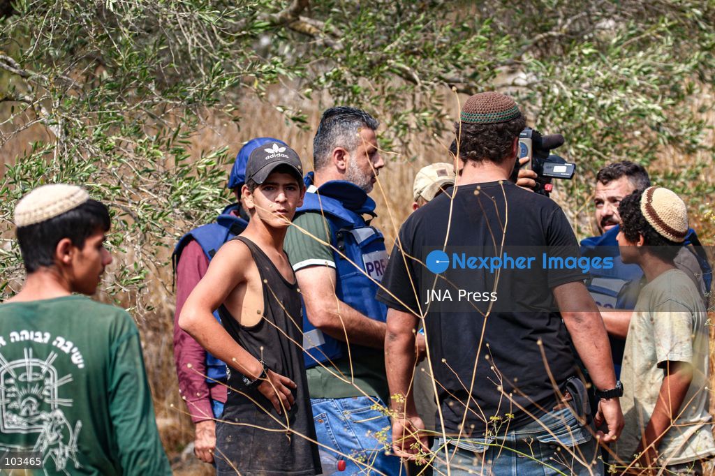 DEIR IBZI, OCCUPIED WEST BANK, OCTOBER 9, 2026: Israeli settlers confront Palestinian farmers, international activists and journalists during the annual olive harvest in the village of Deir Ibzi, west of Ramallah. According to the photographer, settlers attacked and harassed those accompanying the farmers, used pepper spray and prevented residents from completing the harvest on their agricultural land. The incident occurred during the olive harvest season, an important source of income for Palestinian farming communities in the occupied West Bank. Photo by Salman Mohsen Alkhatib / JNA Press (Photo by Salman Mohsen Alkhatib/JNA Press via Nexpher Images)