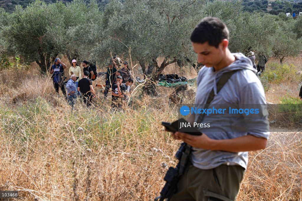 DEIR IBZI, OCCUPIED WEST BANK, OCTOBER 9, 2026: Israeli settlers confront Palestinian farmers, international activists and journalists during the annual olive harvest in the village of Deir Ibzi, west of Ramallah. According to the photographer, settlers attacked and harassed those accompanying the farmers, used pepper spray and prevented residents from completing the harvest on their agricultural land. The incident occurred during the olive harvest season, an important source of income for Palestinian farming communities in the occupied West Bank. Photo by Salman Mohsen Alkhatib / JNA Press (Photo by Salman Mohsen Alkhatib/JNA Press via Nexpher Images)