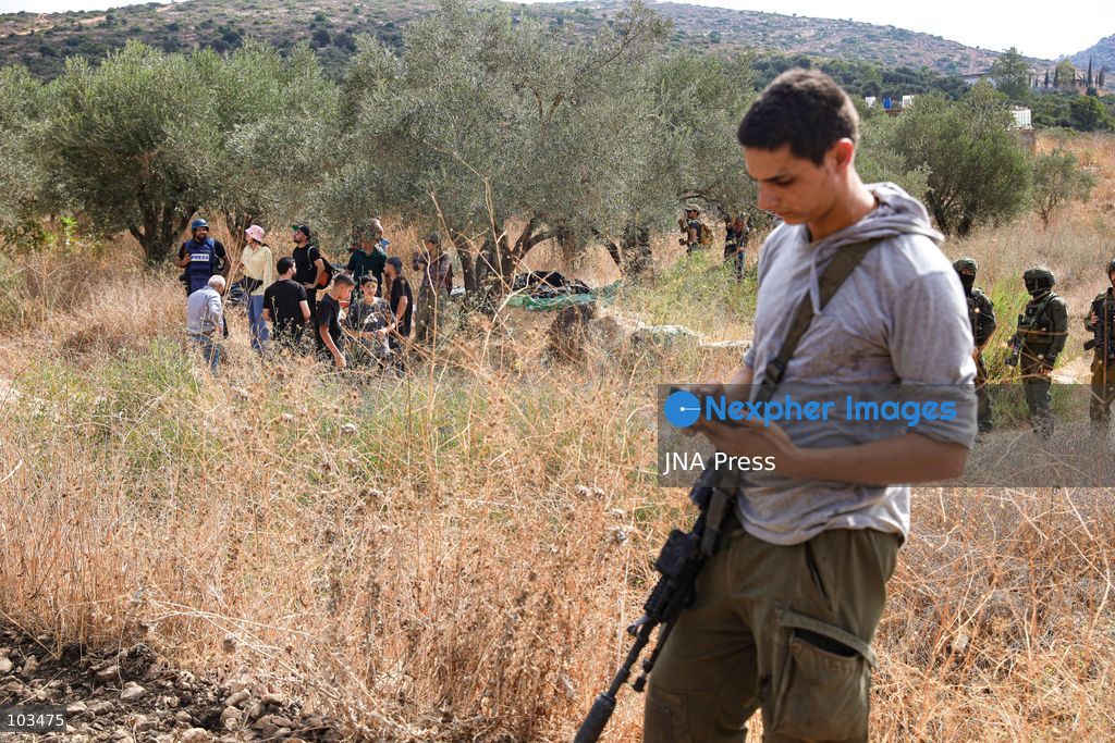 DEIR IBZI, OCCUPIED WEST BANK, OCTOBER 9, 2026: Israeli settlers confront Palestinian farmers, international activists and journalists during the annual olive harvest in the village of Deir Ibzi, west of Ramallah. According to the photographer, settlers attacked and harassed those accompanying the farmers, used pepper spray and prevented residents from completing the harvest on their agricultural land. The incident occurred during the olive harvest season, an important source of income for Palestinian farming communities in the occupied West Bank. Photo by Salman Mohsen Alkhatib / JNA Press (Photo by Salman Mohsen Alkhatib/JNA Press via Nexpher Images)