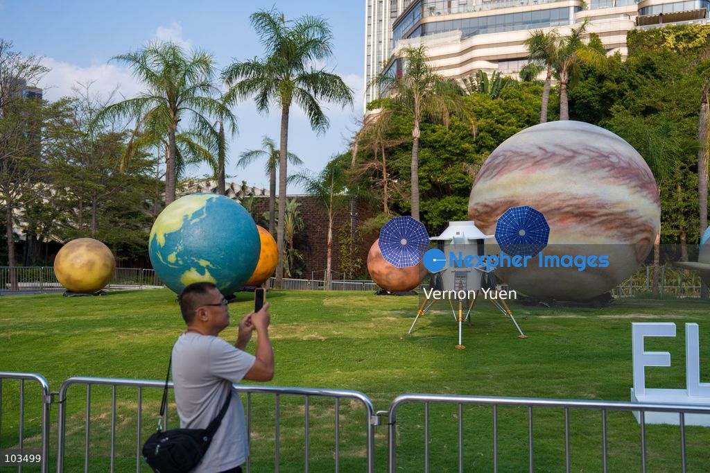 A man taking a photo of a solar system themed display on October 10, 2026 in Hong Kong. (Photo by Vernon Yuen/Nexpher Images)