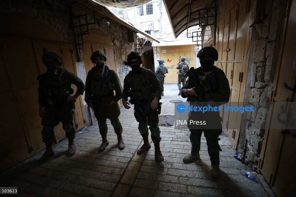 HEBRON, OCCUPIED WEST BANK, OCTOBER 10, 2026: Israeli settlers enter Hebron's Old City under the protection of Israeli forces during an organized visit to the area. Israeli soldiers deployed along streets and around the group as settlers moved through the Old City, where Israeli settlers and Palestinian residents live in close proximity amid longstanding tensions and movement restrictions. Photo by Mosab Shawer / JNA Press. (Photo by Mosab shawer/JNA Press via Nexpher Images)