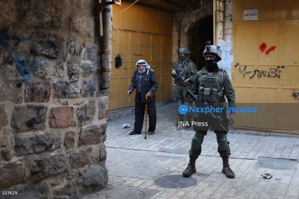 HEBRON, OCCUPIED WEST BANK, OCTOBER 10, 2026: Israeli settlers enter Hebron's Old City under the protection of Israeli forces during an organized visit to the area. Israeli soldiers deployed along streets and around the group as settlers moved through the Old City, where Israeli settlers and Palestinian residents live in close proximity amid longstanding tensions and movement restrictions. Photo by Mosab Shawer / JNA Press. (Photo by Mosab shawer/JNA Press via Nexpher Images)