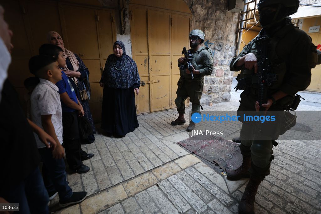 HEBRON, OCCUPIED WEST BANK, OCTOBER 10, 2026: Israeli settlers enter Hebron's Old City under the protection of Israeli forces during an organized visit to the area. Israeli soldiers deployed along streets and around the group as settlers moved through the Old City, where Israeli settlers and Palestinian residents live in close proximity amid longstanding tensions and movement restrictions. Photo by Mosab Shawer / JNA Press. (Photo by Mosab shawer/JNA Press via Nexpher Images)