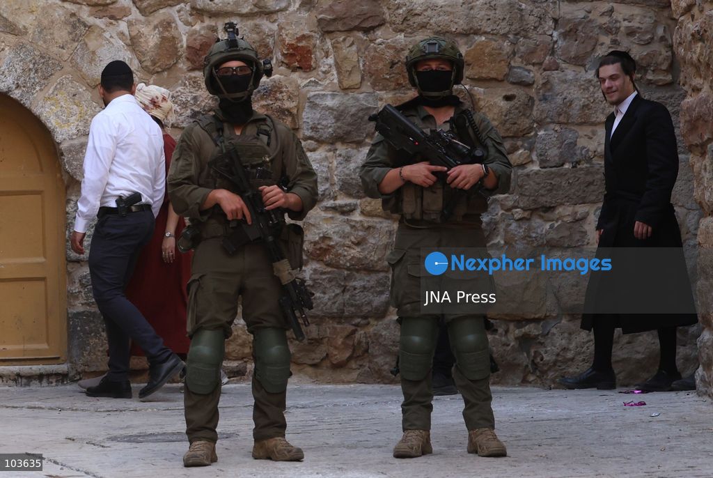 HEBRON, OCCUPIED WEST BANK, OCTOBER 10, 2026: Israeli settlers enter Hebron's Old City under the protection of Israeli forces during an organized visit to the area. Israeli soldiers deployed along streets and around the group as settlers moved through the Old City, where Israeli settlers and Palestinian residents live in close proximity amid longstanding tensions and movement restrictions. Photo by Mosab Shawer / JNA Press. (Photo by Mosab shawer/JNA Press via Nexpher Images)
