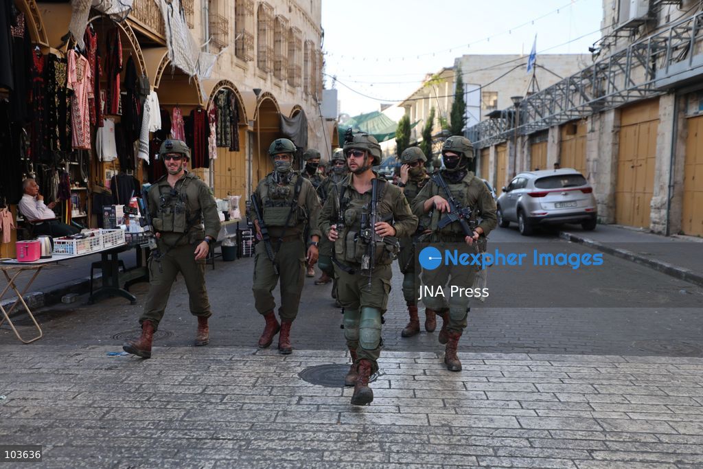 HEBRON, OCCUPIED WEST BANK, OCTOBER 10, 2026: Israeli settlers enter Hebron's Old City under the protection of Israeli forces during an organized visit to the area. Israeli soldiers deployed along streets and around the group as settlers moved through the Old City, where Israeli settlers and Palestinian residents live in close proximity amid longstanding tensions and movement restrictions. Photo by Mosab Shawer / JNA Press. (Photo by Mosab shawer/JNA Press via Nexpher Images)