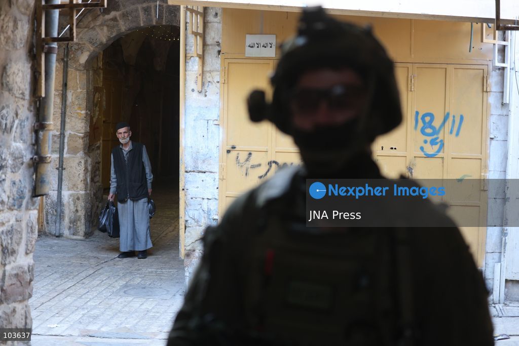 HEBRON, OCCUPIED WEST BANK, OCTOBER 10, 2026: Israeli settlers enter Hebron's Old City under the protection of Israeli forces during an organized visit to the area. Israeli soldiers deployed along streets and around the group as settlers moved through the Old City, where Israeli settlers and Palestinian residents live in close proximity amid longstanding tensions and movement restrictions. Photo by Mosab Shawer / JNA Press. (Photo by Mosab shawer/JNA Press via Nexpher Images)