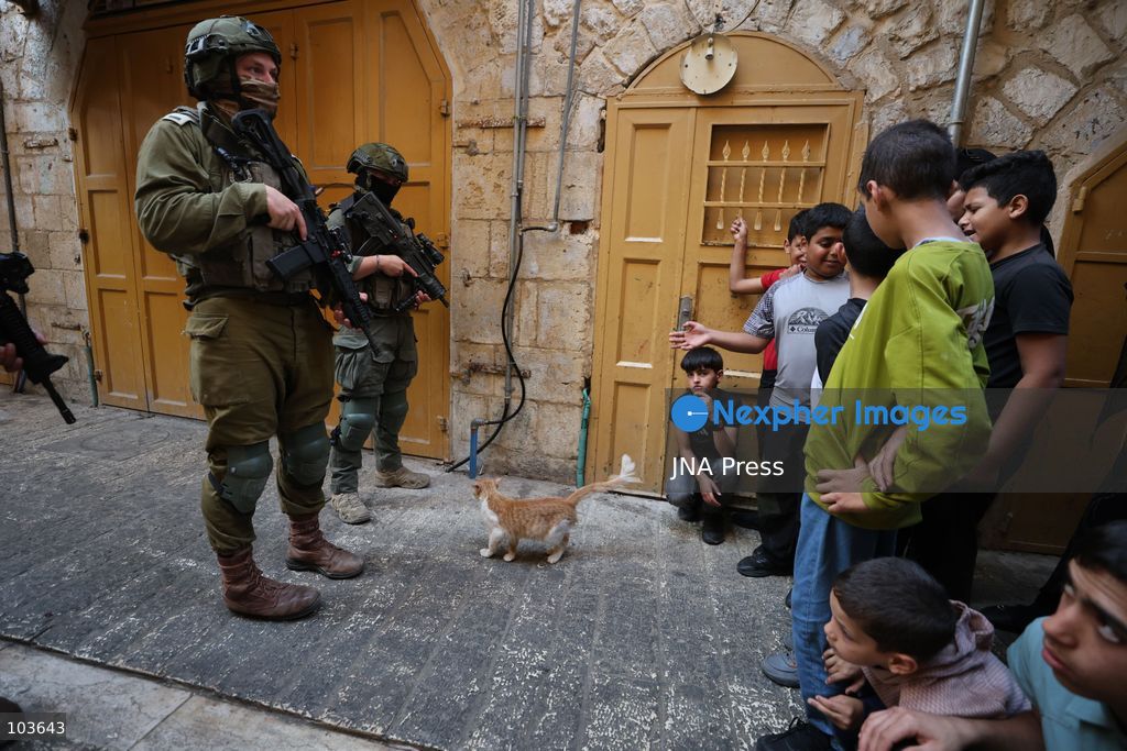 HEBRON, OCCUPIED WEST BANK, OCTOBER 10, 2026: Israeli settlers enter Hebron's Old City under the protection of Israeli forces during an organized visit to the area. Israeli soldiers deployed along streets and around the group as settlers moved through the Old City, where Israeli settlers and Palestinian residents live in close proximity amid longstanding tensions and movement restrictions. Photo by Mosab Shawer / JNA Press. (Photo by Mosab shawer/JNA Press via Nexpher Images)