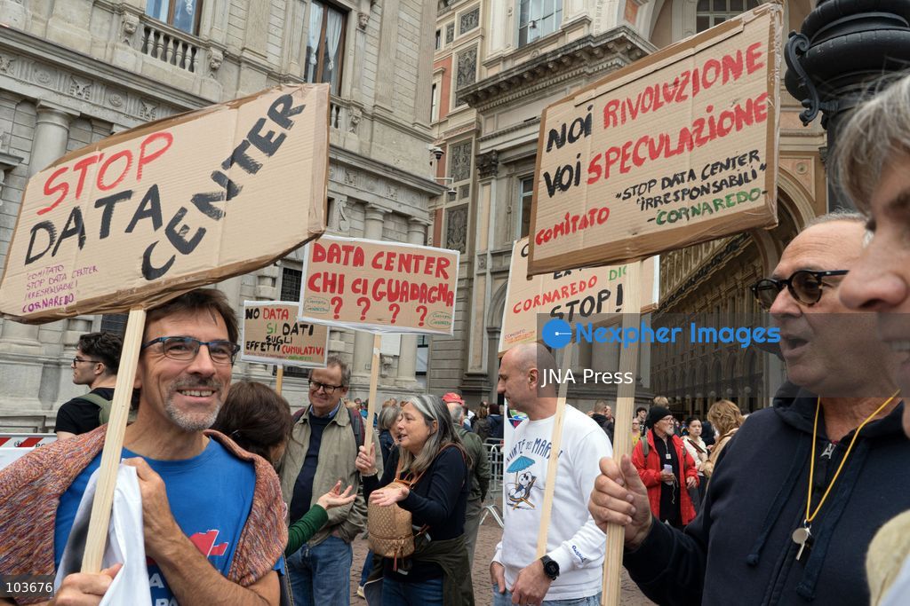 MILAN, ITALY – OCTOBER 10, 2026: Protesters gather for a sit-in in Piazza della Scala in central Milan to oppose the development of new data centers across Lombardy and Italy. The demonstration is organized by the Rete dei Comitati No Data Center (No Data Center Committee Network), which is calling for a moratorium on permits for new facilities. The group also urges public authorities to conduct thorough environmental, urban planning and regional assessments before approving projects. For approved facilities that have not yet begun operating, campaigners are calling for reviews to be reopened if potential microclimate effects and cumulative impacts with existing facilities were not adequately assessed. Lombardy is a major center for Italy’s data center industry. In 2024, the region hosted 67 of Italy’s 168 operational facilities and accounted for approximately 63% of applications for new developments, according to the supplied information. Photo by Calogero Russo / JNA Press. (Photo by calogero russo/JNA Press via Nexpher Images)