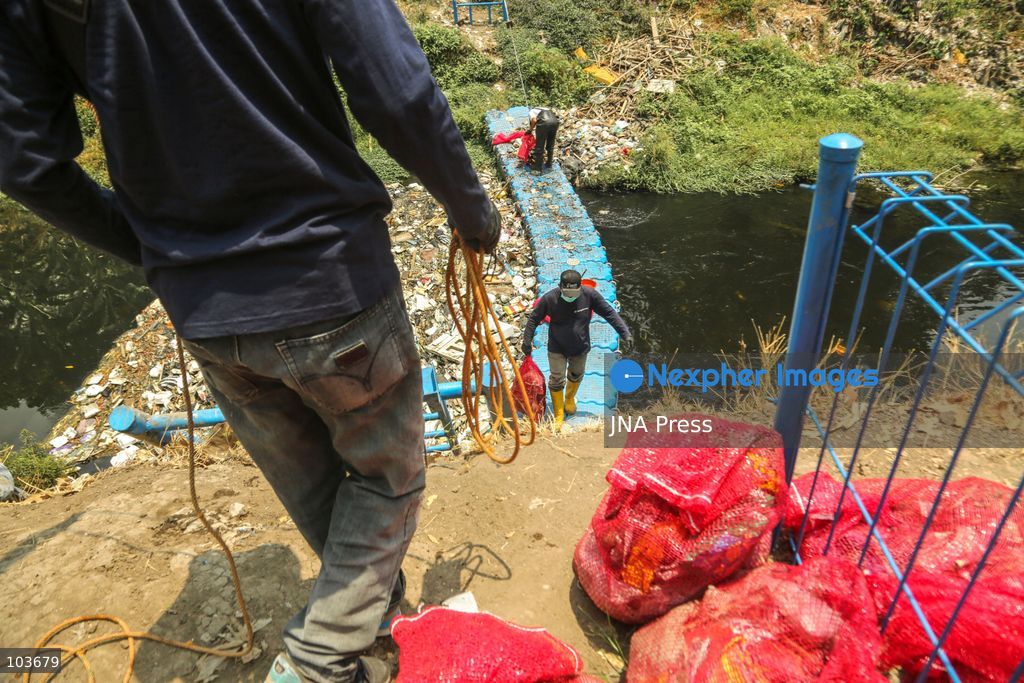 SOLO, CENTRAL JAVA, INDONESIA, OCTOBER 10, 2026: Volunteers collect and sort waste trapped by a trash boom installed in the Premulung River in Joyontakan, Solo, as part of the Sungai Lestari program aimed at reducing river pollution and strengthening community-based waste management. The initiative, involving UNDP Indonesia, the Bina Karta Lestari Foundation and the Joyo Gumregah community group, conducts waste collection three times a week, with organizers saying between 80 and 100 kilograms of waste is collected during each operation. The material is sorted into organic, inorganic and hazardous waste categories. Photo by Yoma Suryadi / JNA PRESS (Photo by Yoma Times Suryadi/JNA Press via Nexpher Images)