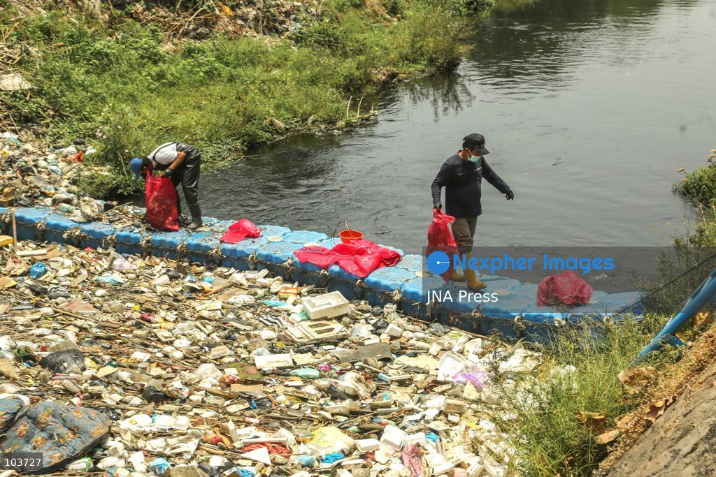 SOLO, CENTRAL JAVA, INDONESIA, OCTOBER 10, 2026: Volunteers collect and sort waste trapped by a trash boom installed in the Premulung River in Joyontakan, Solo, as part of the Sungai Lestari program aimed at reducing river pollution and strengthening community-based waste management. The initiative, involving UNDP Indonesia, the Bina Karta Lestari Foundation and the Joyo Gumregah community group, conducts waste collection three times a week, with organizers saying between 80 and 100 kilograms of waste is collected during each operation. The material is sorted into organic, inorganic and hazardous waste categories. Photo by Yoma Suryadi / JNA PRESS (Photo by Yoma Times Suryadi/JNA Press via Nexpher Images)