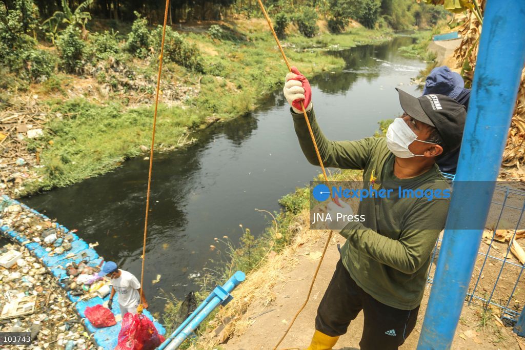 SOLO, CENTRAL JAVA, INDONESIA, OCTOBER 10, 2026: Volunteers collect and sort waste trapped by a trash boom installed in the Premulung River in Joyontakan, Solo, as part of the Sungai Lestari program aimed at reducing river pollution and strengthening community-based waste management. The initiative, involving UNDP Indonesia, the Bina Karta Lestari Foundation and the Joyo Gumregah community group, conducts waste collection three times a week, with organizers saying between 80 and 100 kilograms of waste is collected during each operation. The material is sorted into organic, inorganic and hazardous waste categories. Photo by Yoma Suryadi / JNA PRESS (Photo by Yoma Times Suryadi/JNA Press via Nexpher Images)