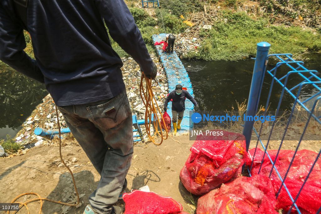 SOLO, CENTRAL JAVA, INDONESIA, OCTOBER 10, 2026: Volunteers collect and sort waste trapped by a trash boom installed in the Premulung River in Joyontakan, Solo, as part of the Sungai Lestari program aimed at reducing river pollution and strengthening community-based waste management. The initiative, involving UNDP Indonesia, the Bina Karta Lestari Foundation and the Joyo Gumregah community group, conducts waste collection three times a week, with organizers saying between 80 and 100 kilograms of waste is collected during each operation. The material is sorted into organic, inorganic and hazardous waste categories. Photo by Yoma Suryadi / JNA PRESS (Photo by Yoma Times Suryadi/JNA Press via Nexpher Images)