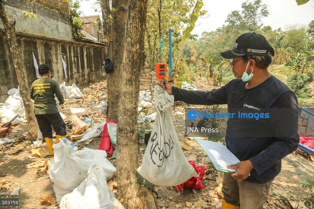 SOLO, CENTRAL JAVA, INDONESIA, OCTOBER 10, 2026: Volunteers collect and sort waste trapped by a trash boom installed in the Premulung River in Joyontakan, Solo, as part of the Sungai Lestari program aimed at reducing river pollution and strengthening community-based waste management. The initiative, involving UNDP Indonesia, the Bina Karta Lestari Foundation and the Joyo Gumregah community group, conducts waste collection three times a week, with organizers saying between 80 and 100 kilograms of waste is collected during each operation. The material is sorted into organic, inorganic and hazardous waste categories. Photo by Yoma Suryadi / JNA PRESS (Photo by Yoma Times Suryadi/JNA Press via Nexpher Images)