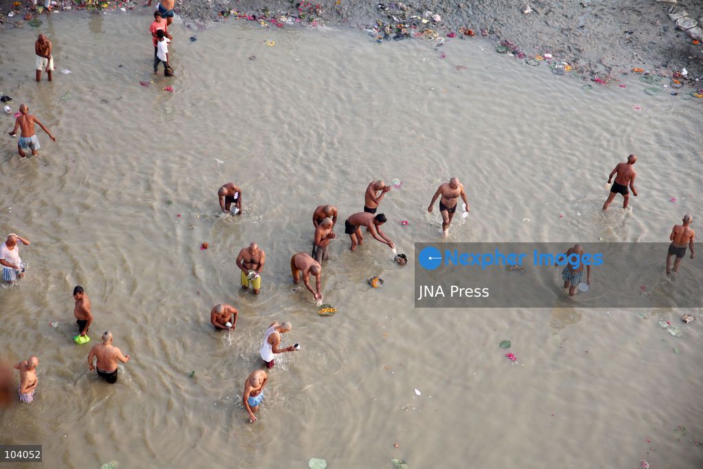 PRAYAGRAJ, INDIA, OCTOBER 11, 2026: Hindu devotees take a holy dip in the Ganga River at Phaphamau in Prayagraj, Uttar Pradesh, on the first day of the nine-day Navratri festival. The religious festival is dedicated to the worship of the Hindu goddess Durga and her nine forms, with devotees observing prayers, fasting and traditional rituals throughout the celebrations. Photo by Jitendra Prakash / JNA Press. (Photo by Jitendra Prakash/JNA Press via Nexpher Images)
